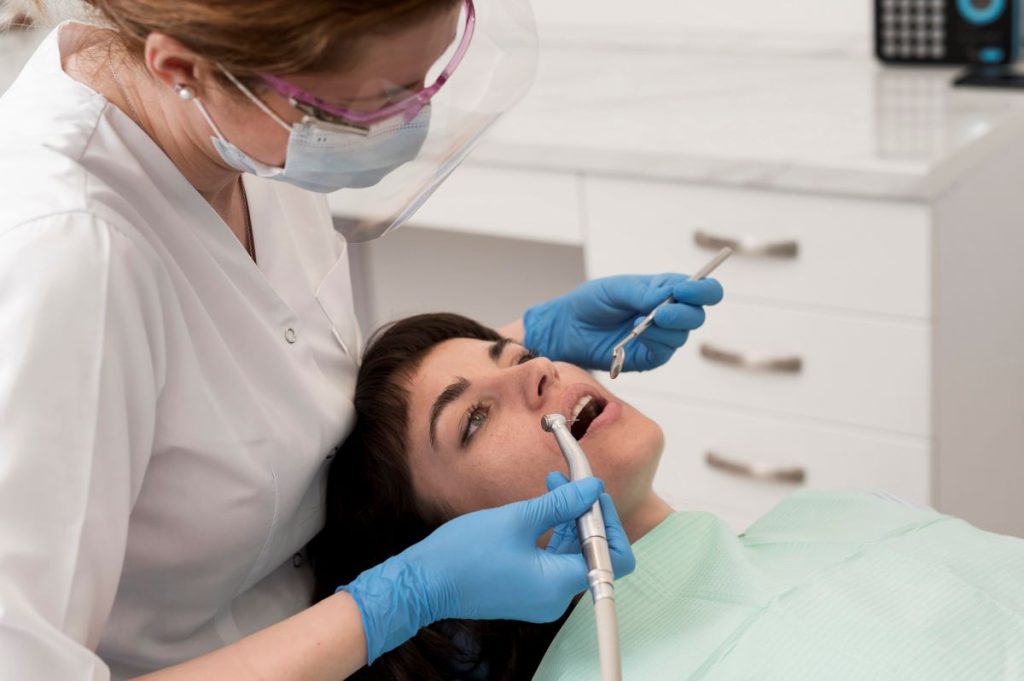 Dentist performing root canal treatment on a patient in a safe, comfortable clinic