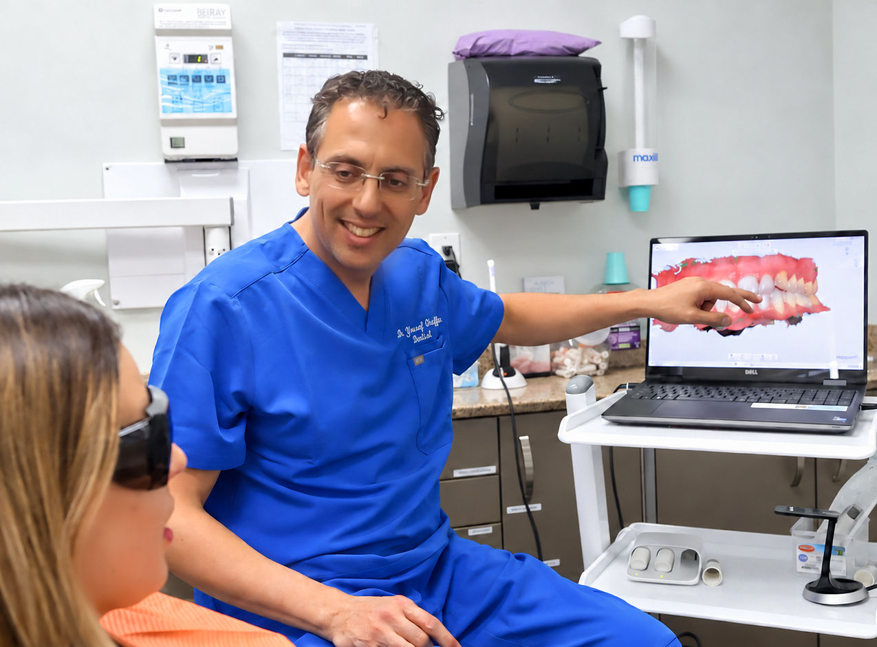 Dr. Yousef Ghaffar reviewing a smile plan with a patient