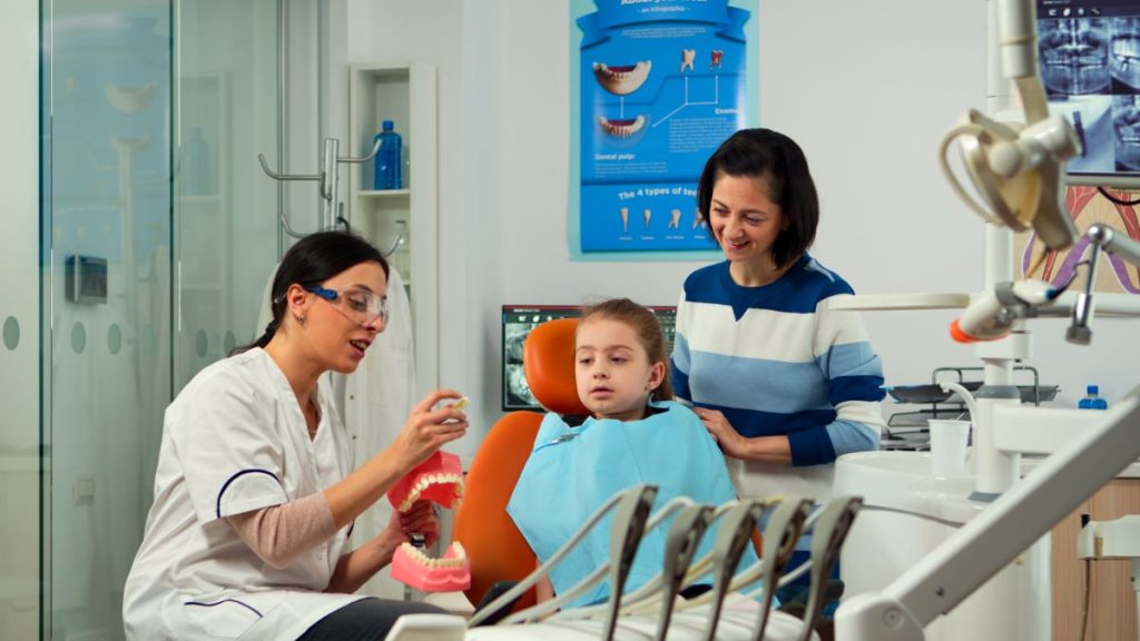 Dentist teaching preventive dentistry for families to mother and child in Burlington