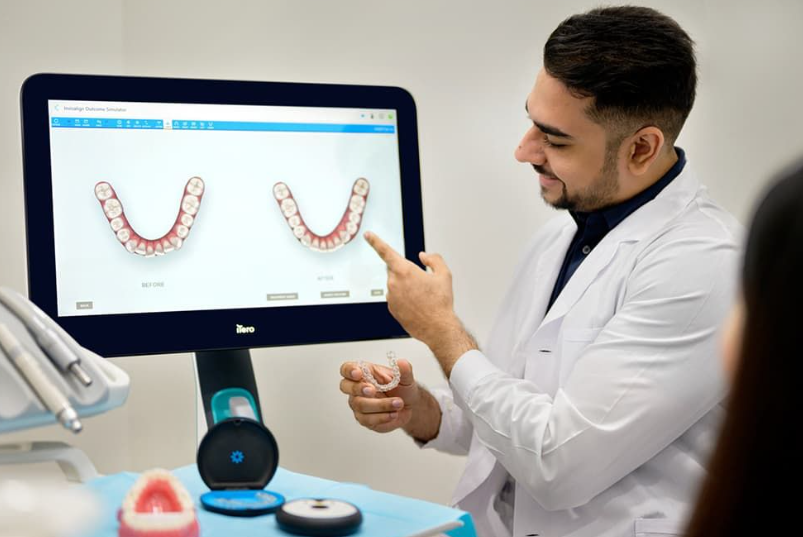 Dentist showing Invisalign treatment using iTero digital scanner for orthodontic care.