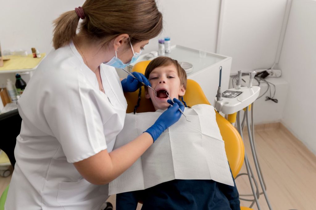 Child receiving dental sealant treatment from dentist in a modern, safe clinic