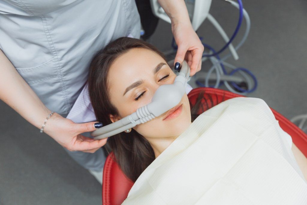 Patient receiving nitrous oxide (laughing gas) for safe and comfortable dental sedation.