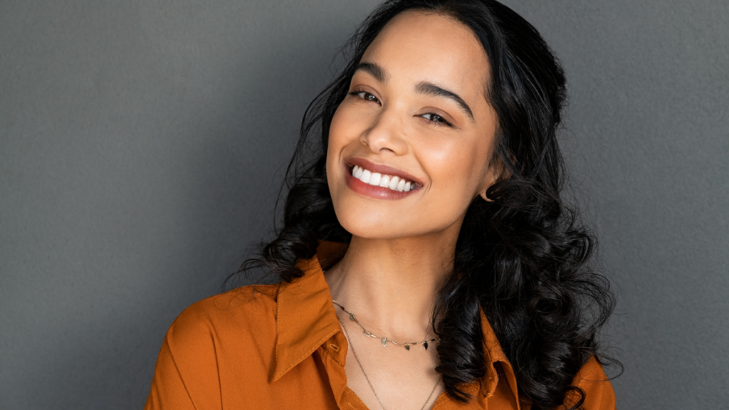 Young woman smiling, showing results of her smile makeover.