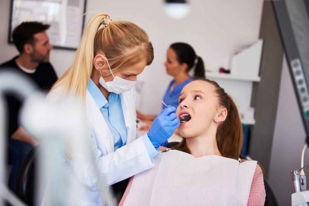 Dentist examining teenager for preventive dentistry for families in Burlington