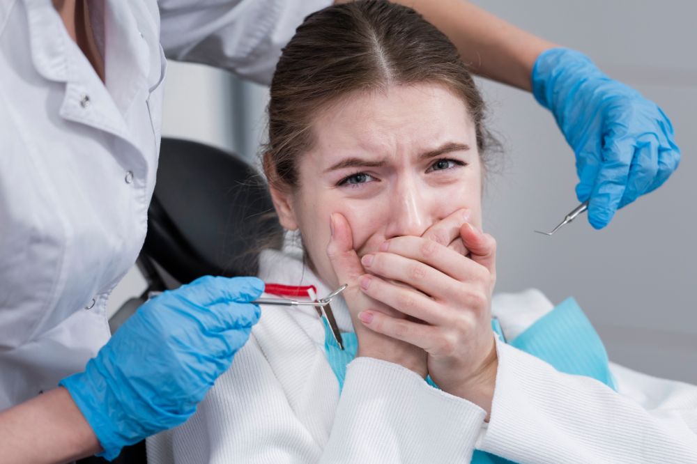 A young woman receiving emergency dental care, showing concern due to tooth pain.