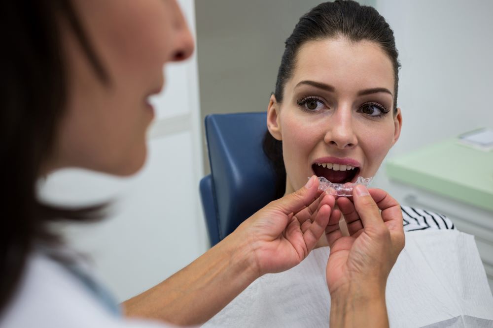 Orthodontist fitting Invisalign aligners for effective orthodontic treatment.